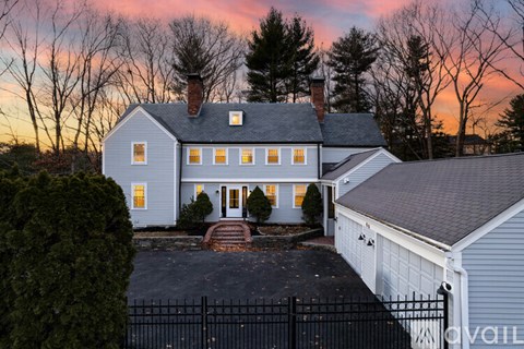 A house with a white exterior and a black fence.