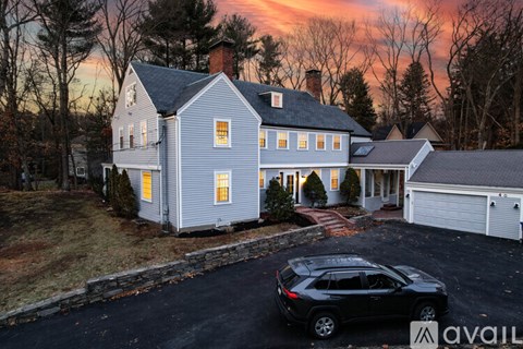A house with a car parked in front of it.