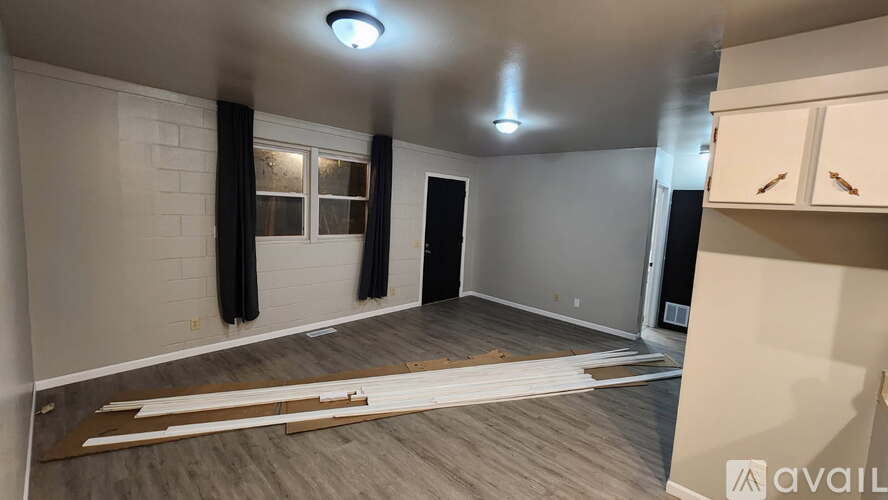 A room with a wooden floor and a ceiling light is available for rent.
