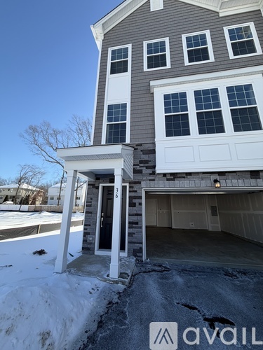 A house with a garage and a white door.