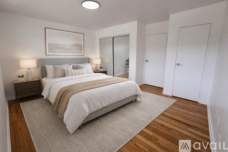A bedroom with a large bed and a painting on the wall.