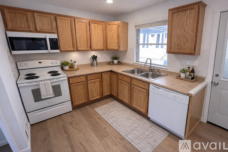 A kitchen with wooden cabinets and white appliances.