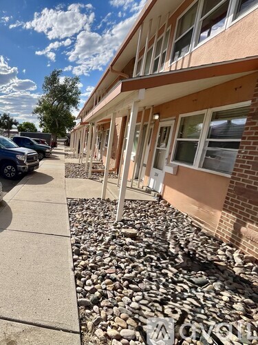A building with a gravel area in front of it.