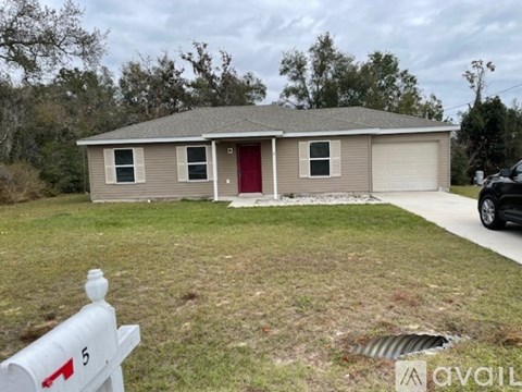 A house with a red door is for sale.