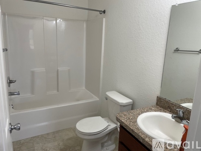 A white toilet sits next to a sink in a bathroom.