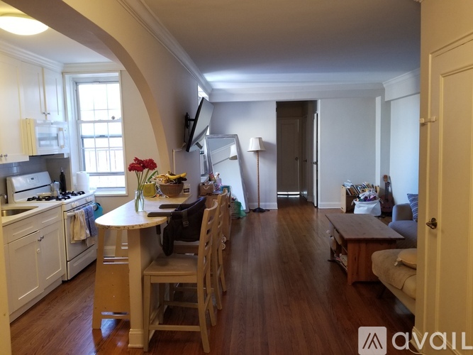 A kitchen with a table and chairs in the middle of the room.