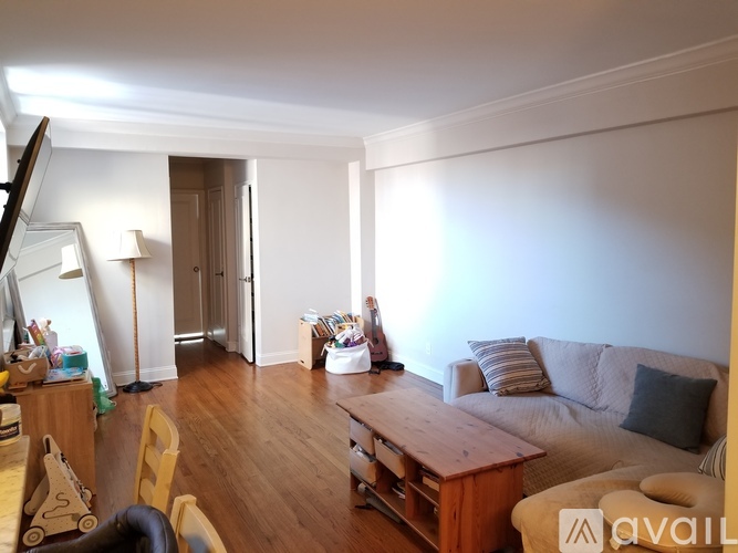 A living room with a couch, a coffee table, and a chair.
