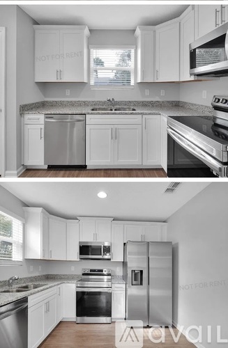A modern kitchen with white cabinets and stainless steel appliances.