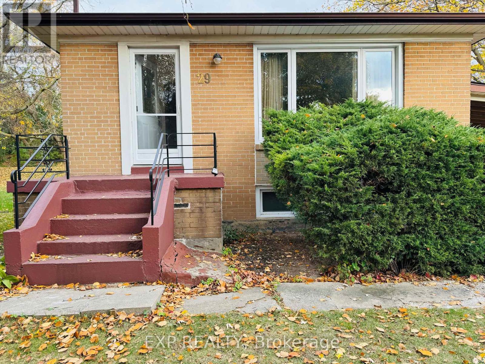 A house with a red staircase leading to the front door.