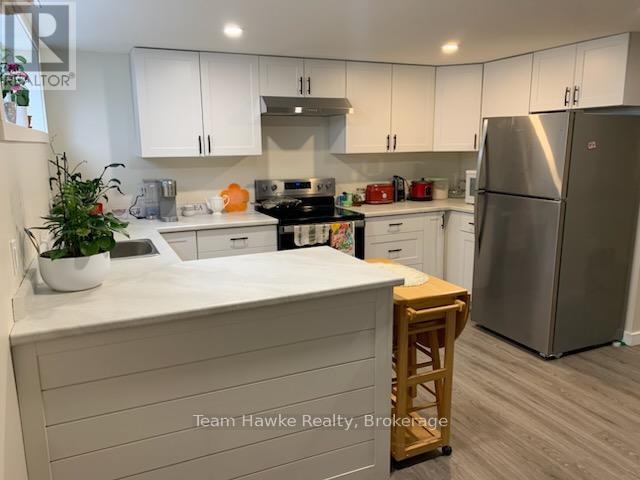 A kitchen with white cabinets and a white countertop.