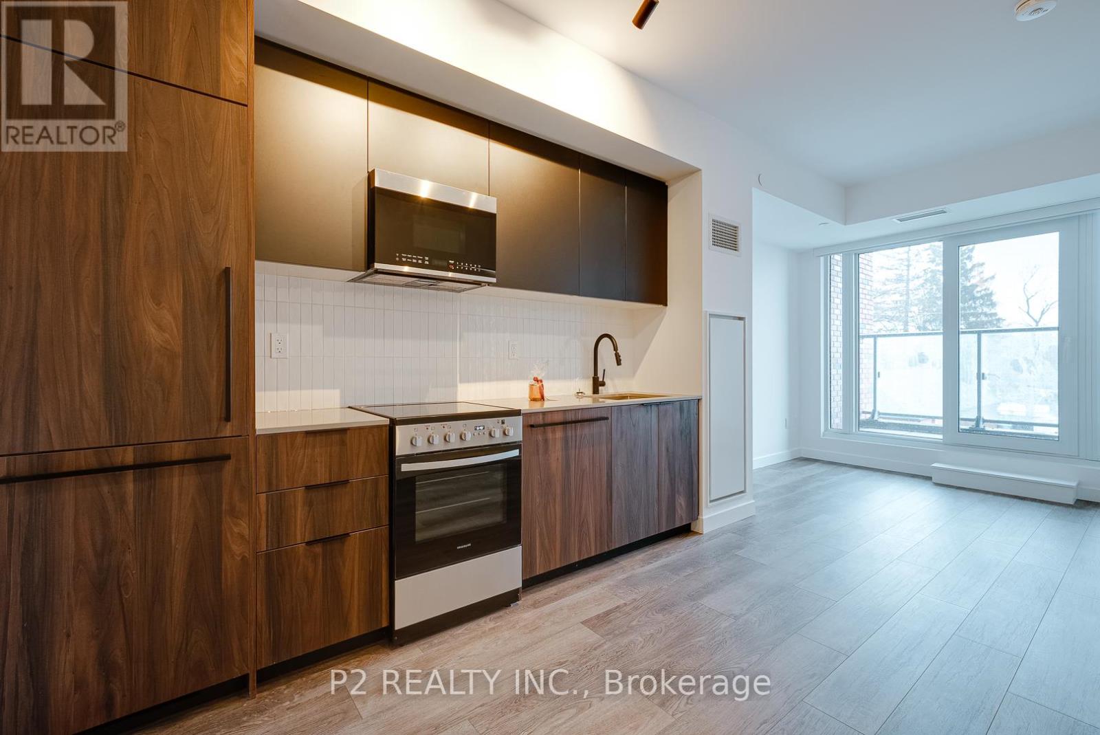 A modern kitchen with wooden cabinets and a stainless steel oven.