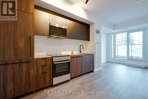 A modern kitchen with wooden cabinets and a stainless steel oven.