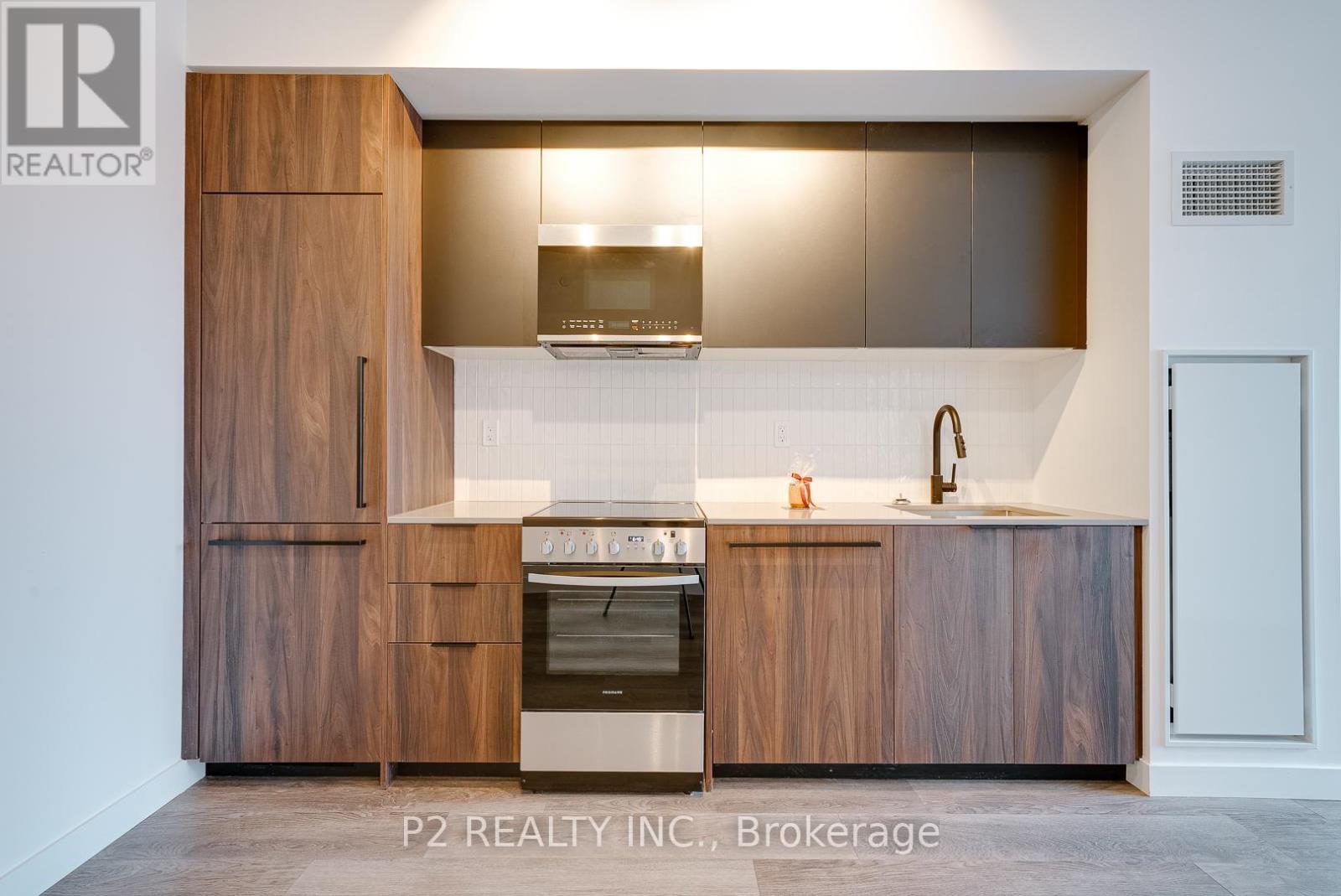 A modern kitchen with wooden cabinets and a stainless steel oven.