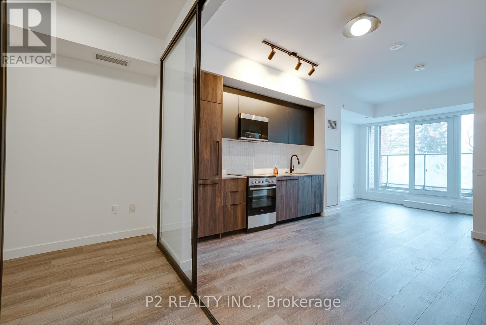 A modern kitchen with wooden cabinets and a large island.