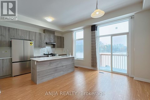 A spacious kitchen with wooden floors and a large island.