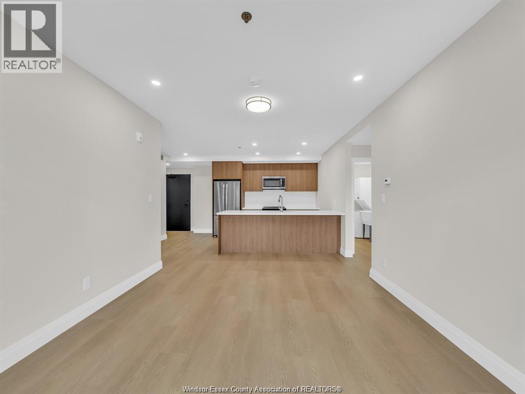 A spacious room with a wooden floor and a reception desk.