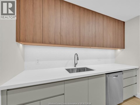 A kitchen with a sink and a counter.