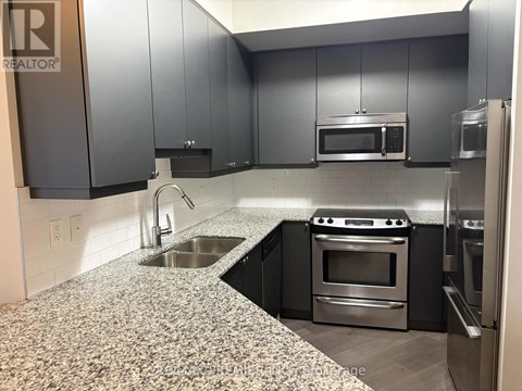 A kitchen with granite countertops and stainless steel appliances.