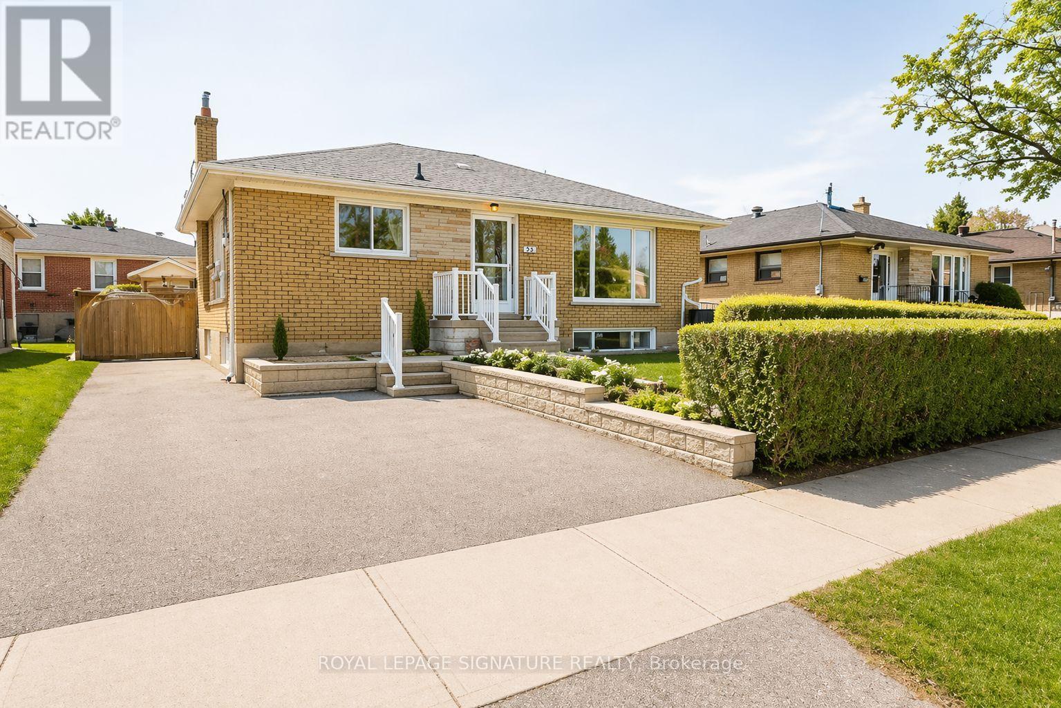 A house with a driveway and a lawn in front.