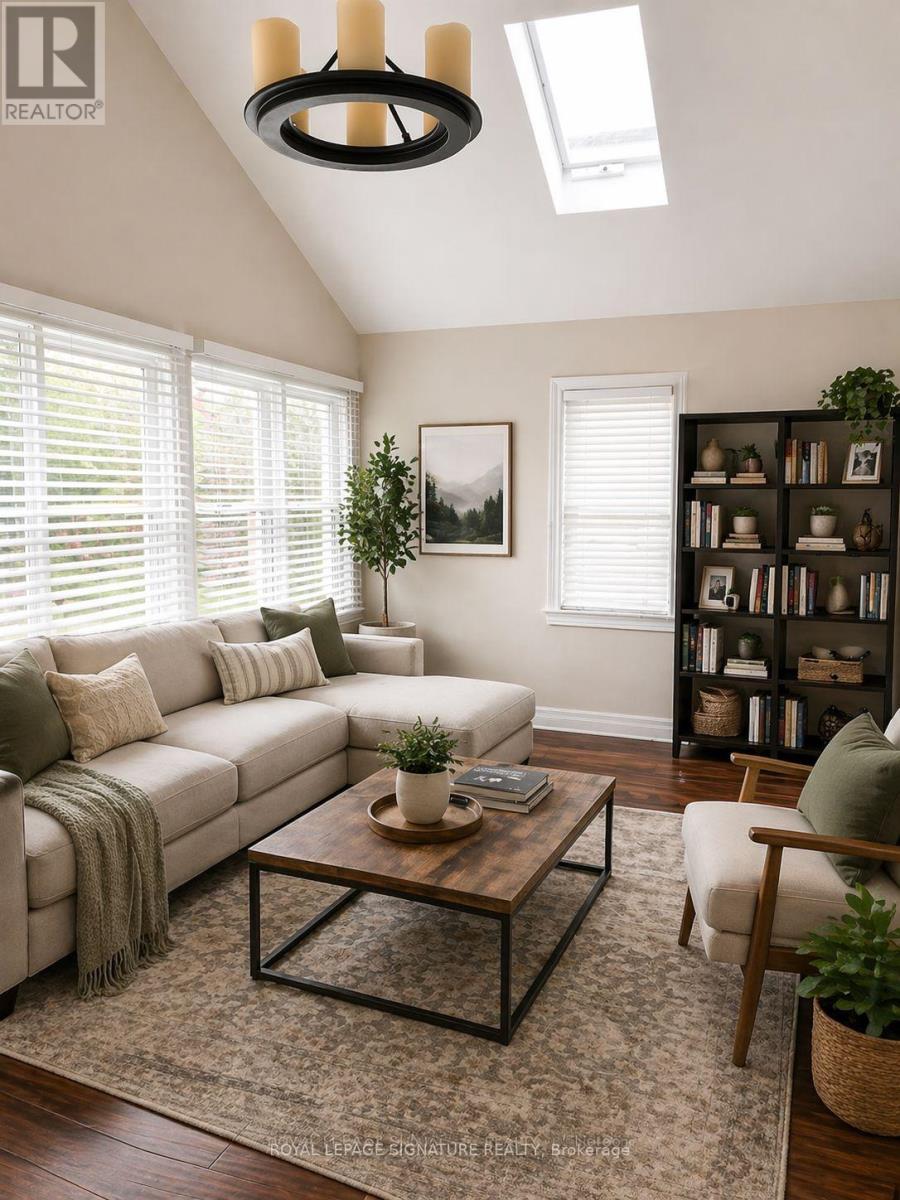 A living room with a large couch, a coffee table, and a bookshelf.
