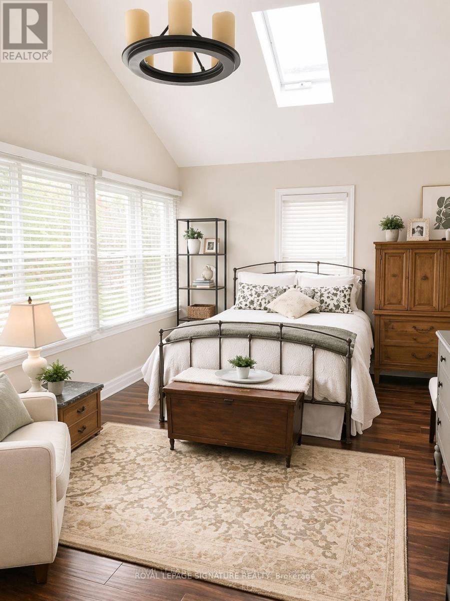 A bedroom with a bed, nightstand, and chair.