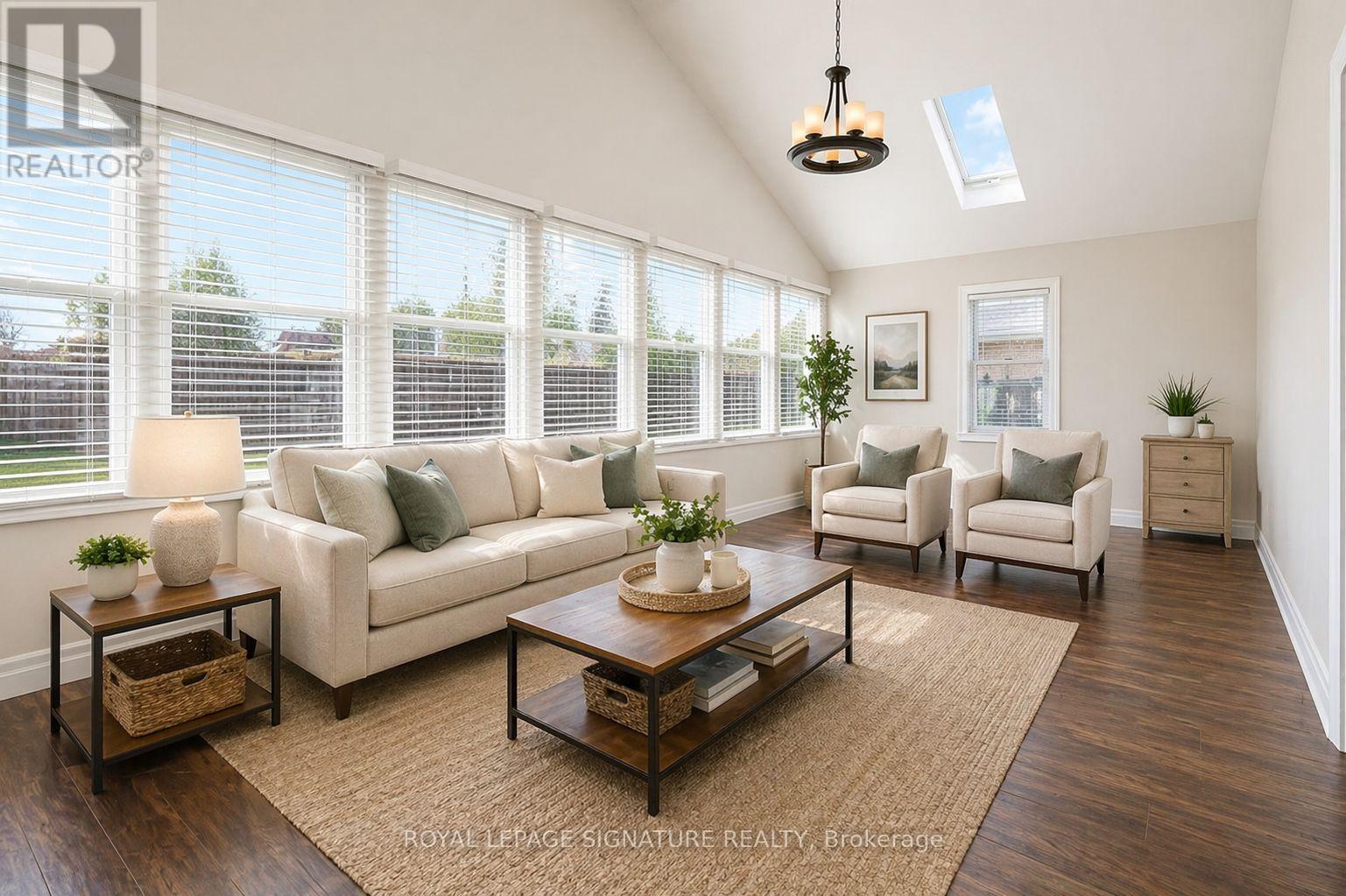 A well-lit living room with a large window and a skylight.