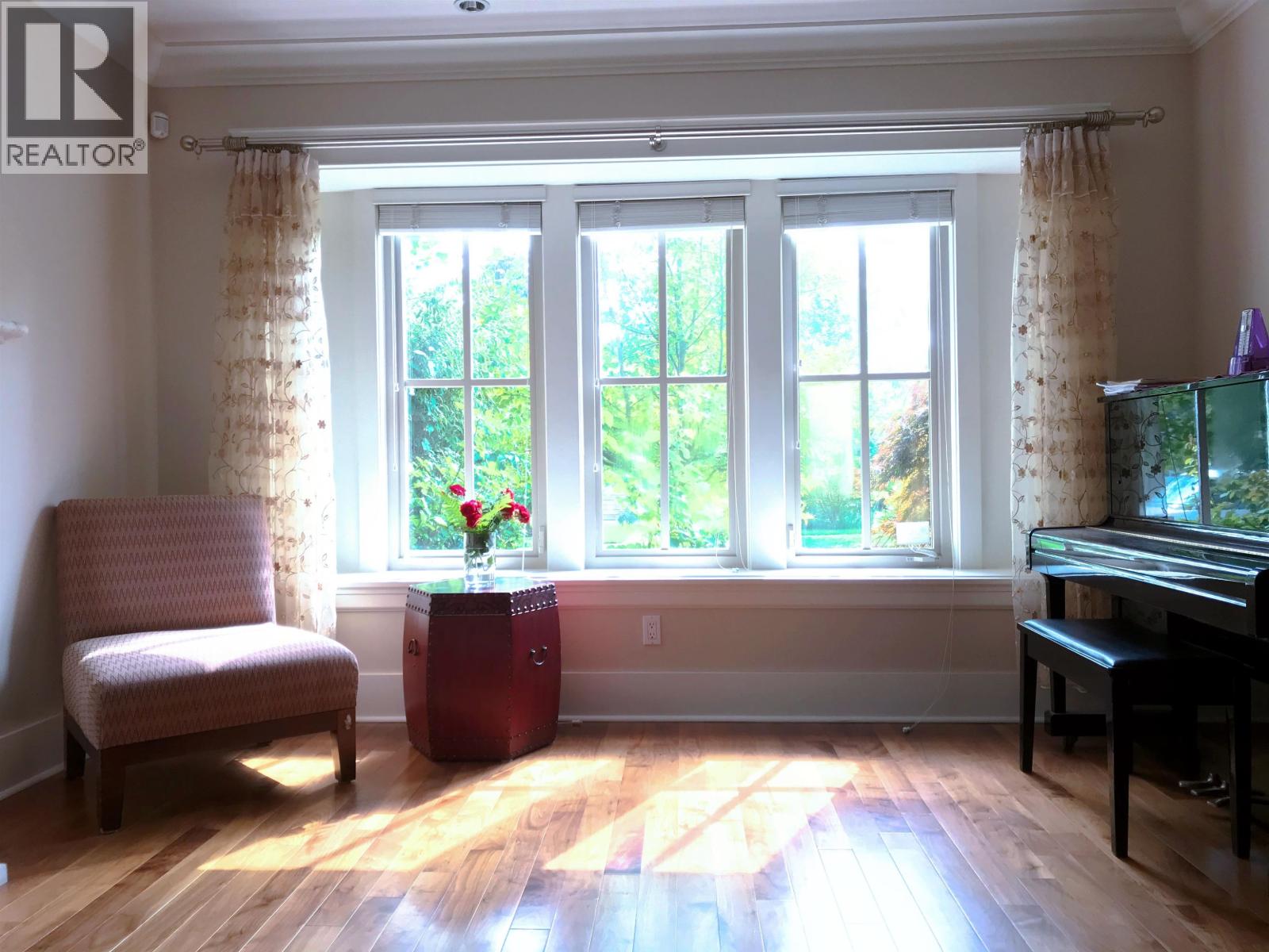 A room with a chair, a table, and a piano.