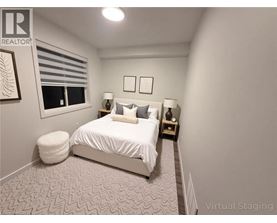 A bedroom with a bed, two lamps, and a window.