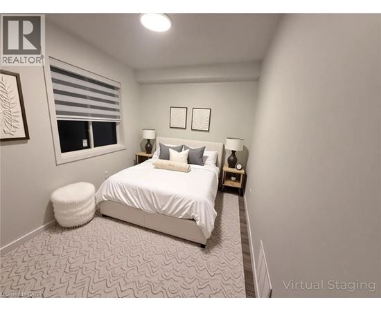A bedroom with a bed, two lamps, and a window.