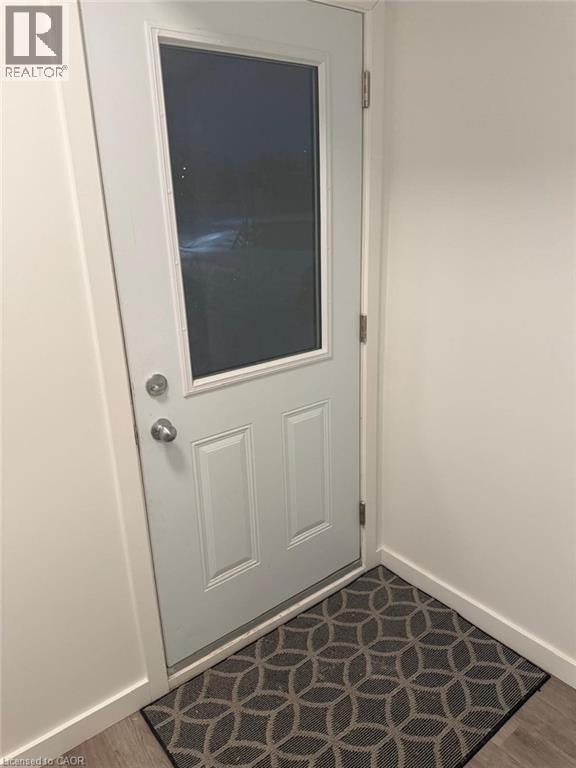 A white door with a glass window and a doorknob.