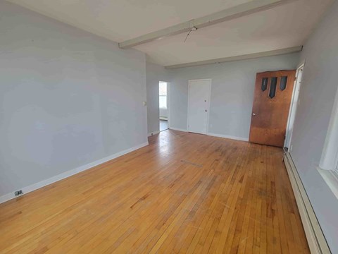 A room with wooden floors and white walls.