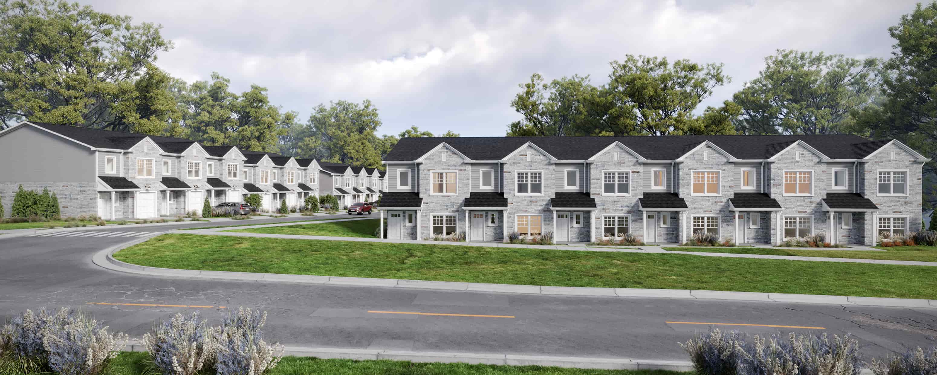 A row of houses with a curved road in front.
