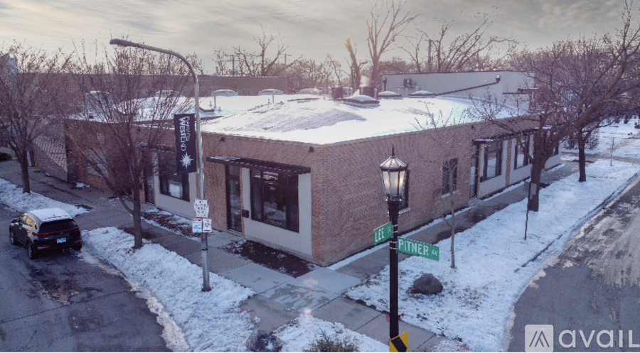 A street view of a building with a car parked in front of it.