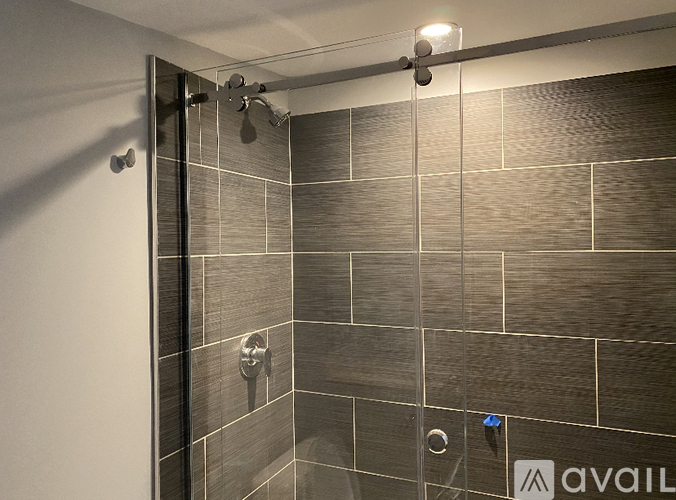 A bathroom with a shower and tiled walls.