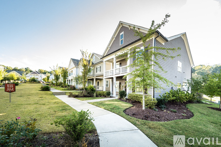 A house with a well-maintained lawn and a walkway leading to the front door.