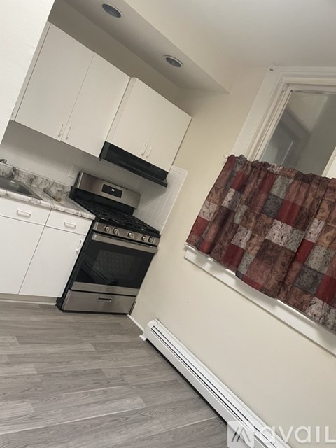 A kitchen with a stove and oven built into the cabinetry.