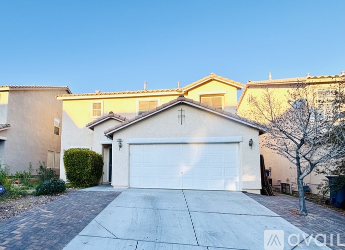 A house with a white garage door is for sale.