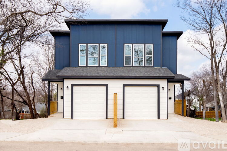 A two-story house with a garage on the ground floor.