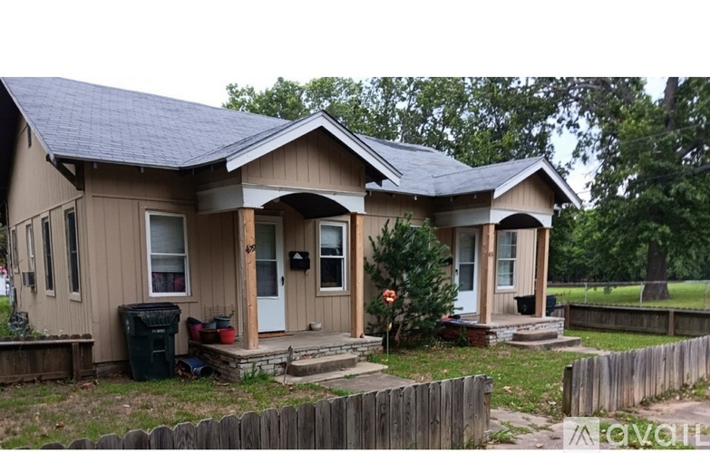 A house with a brown exterior and a black roof.