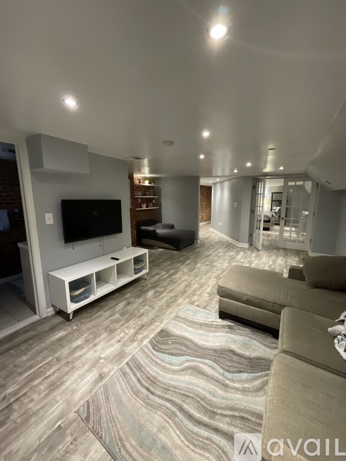 A living room with a television and a couch.