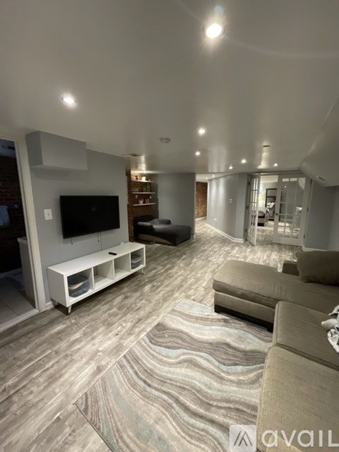 A living room with a television and a couch.