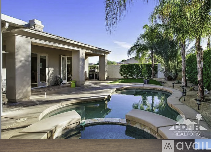 A house with a pool in the backyard.