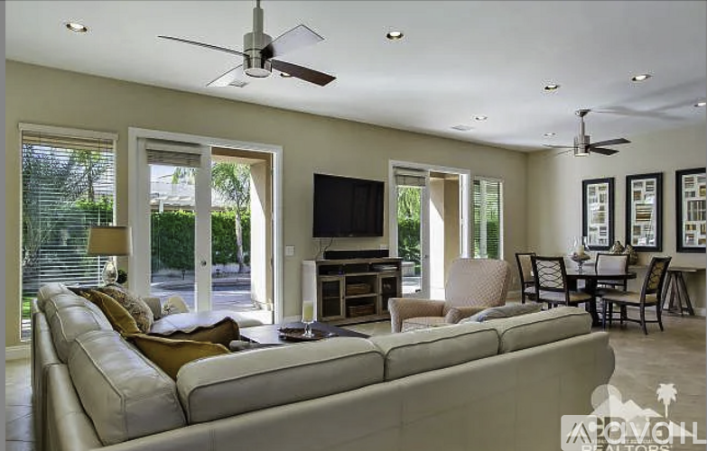 A living room with a large couch and a flat screen TV.