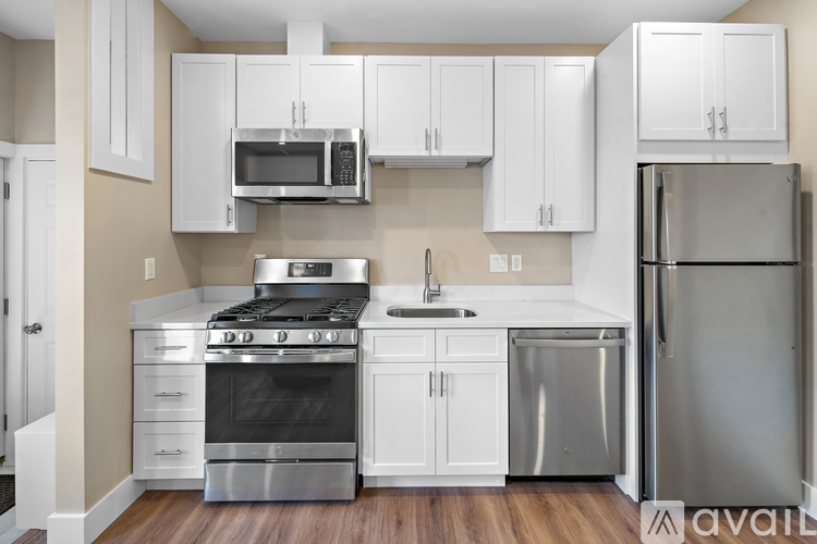 A kitchen with white cabinets and stainless steel appliances.
