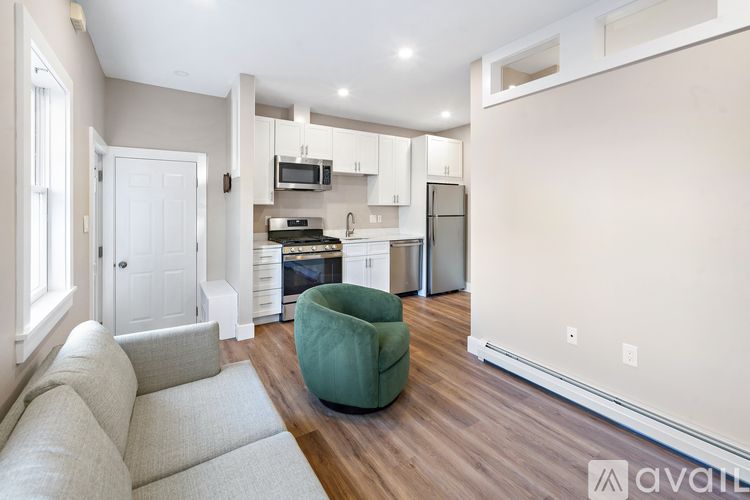 A kitchen with a white door and a green bean bag chair.