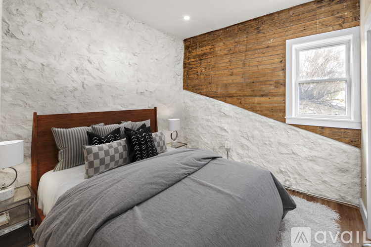A bedroom with a large bed and a wooden headboard.