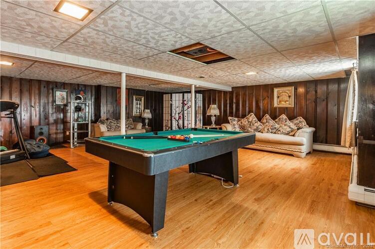A room with a pool table and a couch.