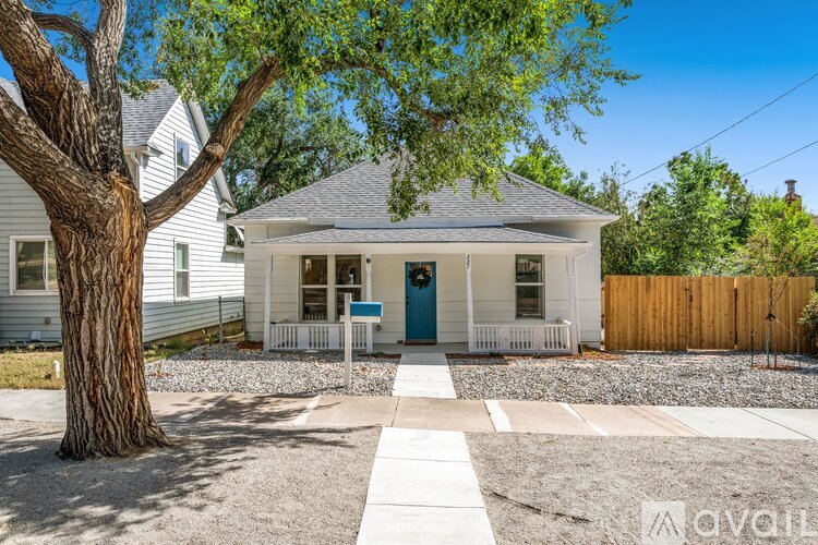 A house with a blue door is for sale.