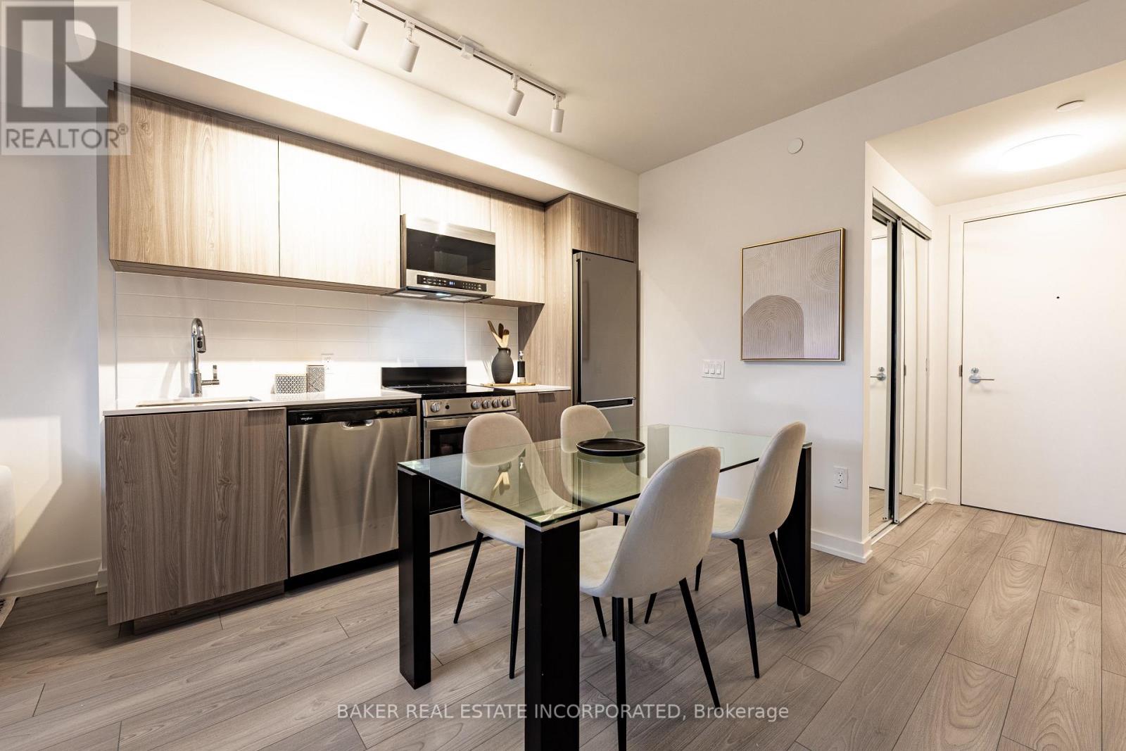 A modern kitchen with a dining table and chairs.