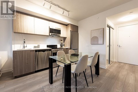 A modern kitchen with a dining table and chairs.